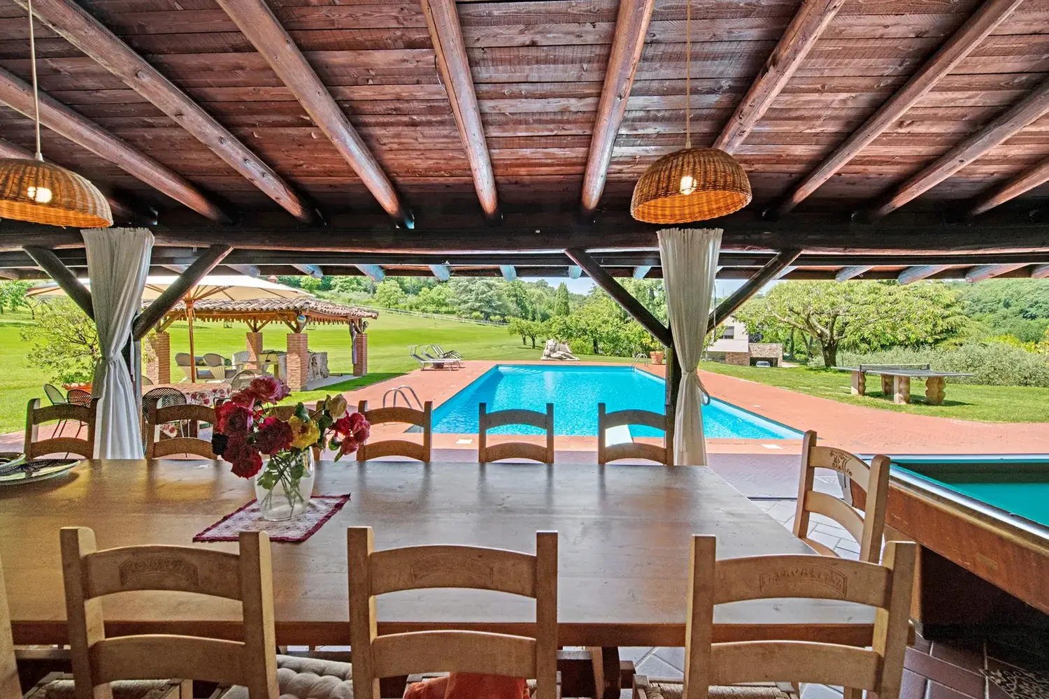 The pool seen through the open windows of the pool house at Cavallina Retreat